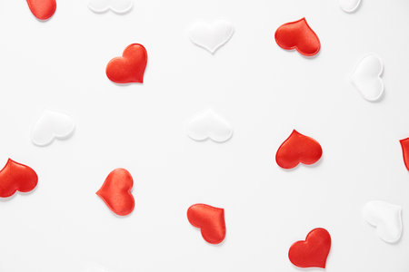 Red and white silk hearts isolated on white background. Valentines day or Wedding romantic concept, top view, copy space, flat layの写真素材