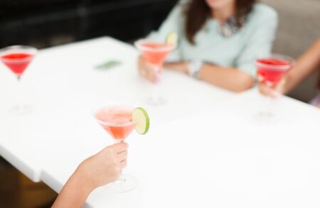 women drink cocktails at the restaurant celebratingの写真素材