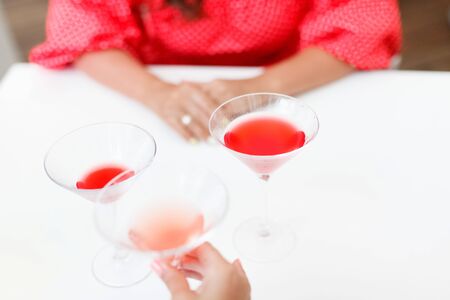 women drink cocktails at the restaurant celebratingの写真素材