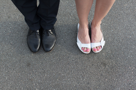 Valentine's Day legs man and woman couple pants asphalt shoes sandals manicureの写真素材
