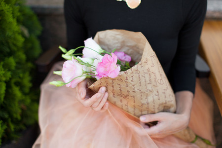 woman with a bouquet of flowers beautiful hand skirt tutu give flowers summerの写真素材