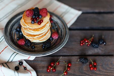 pancakes with honey and berries for breakfastの写真素材
