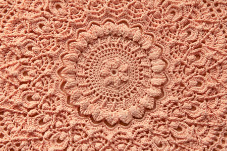 Beautiful closeup crochet doily on wooden background