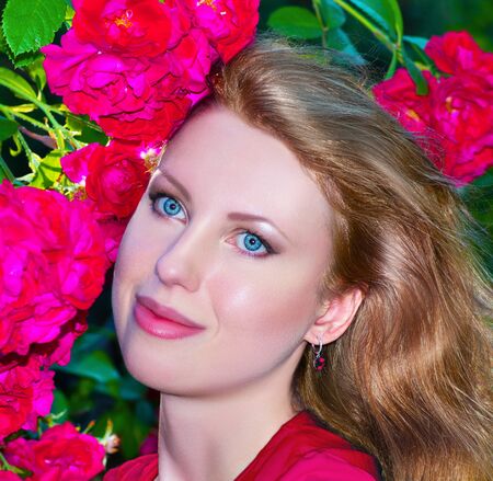 beautiful young woman with red rosesの写真素材