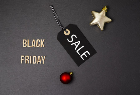 Black background and black price label.  Black Friday. Sales concept. Copy space.  Black paper label against a dark grey background. Black Friday shopping sale concept with Black ticket Sale tag close up on black background.の写真素材
