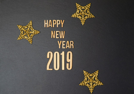 2019 on black background. Wooden sign 2019 on black. Design for a greeting card.