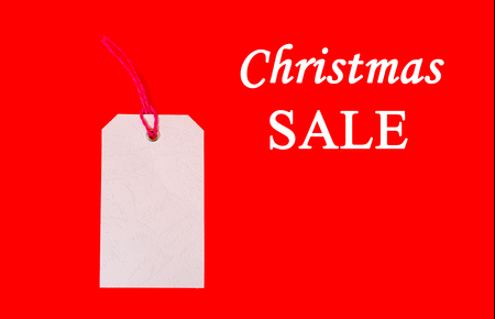 White price tag on red background. Plain price tag.の写真素材