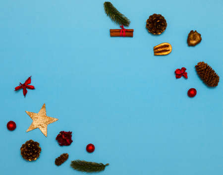 Christmas flat lay background on blue with copy space. Organic nature decorations.