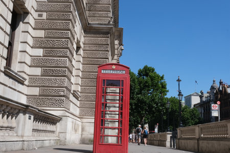 UK red phone box on the London Central Streets. Red British Phone Booth, London background. . High...