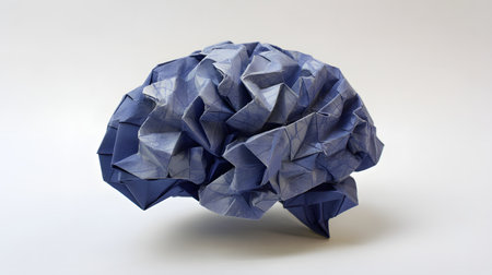 Blue crumpled paper in the origami shape of a human brainの素材