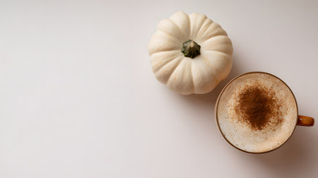 Autumn composition. Cup of coffee, pumpkins, and spices on a white background. Flat lay, top view. Pumpkin latte or cappuccino with cinnamon.の素材