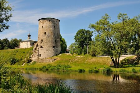 View of the Gremyachaya tower (part of the medieval Pskov fortress) over the Pskova river, Pskov, Russiaの写真素材
