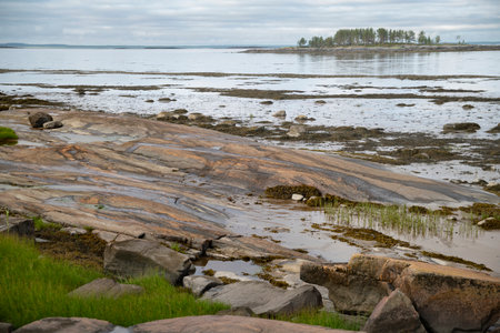 A view over a small stone island across the strait, the White Sea, Russiaの写真素材