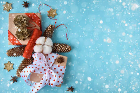 Holiday composition with cones and gift box on a blue background. Merry christmas and happy new year greeting cardの写真素材