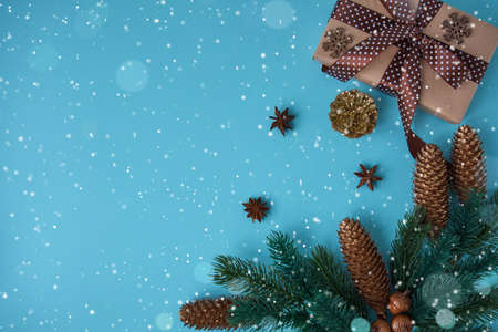 Holiday composition with cones and gift box on a blue background. Merry christmas and happy new year greeting cardの写真素材