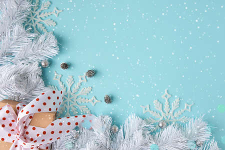 Holiday composition with cones and gift box on a blue background. Merry christmas and happy new year greeting cardの写真素材