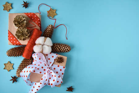 Holiday composition with cones and gift box on a blue background. Merry christmas and happy new year greeting cardの写真素材
