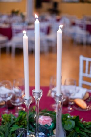 Close-up of candles standing on a table at a wedding reception.の写真素材