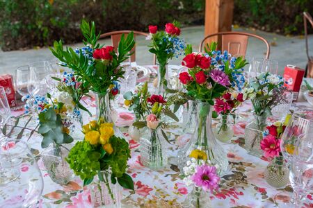 Wedding reception photo. Glasses and flowers on tables. No people.の写真素材