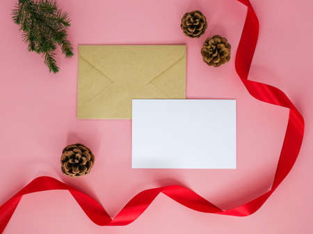 Envelope and christmas decoration on a pink background.の写真素材