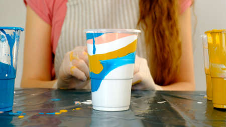 Fluid art technique. Female artist works on abstract fluid art painting.の写真素材
