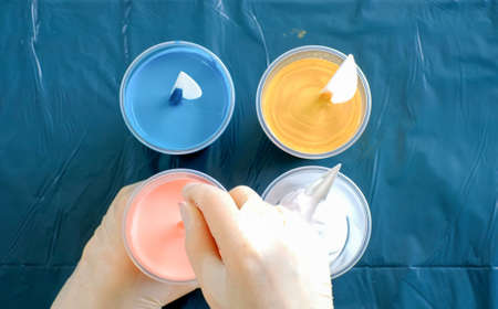 Fluid art technique. Artist works on abstract fluid art painting.の写真素材