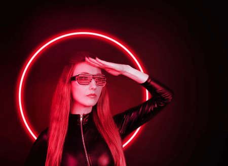 Futuristic woman with neon light glasses. Red colorの写真素材