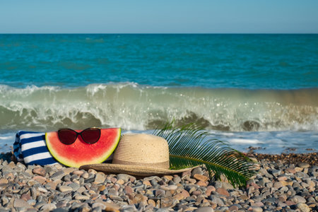 A hat, sunglasses, a watermelon, a tropical leaf.の写真素材