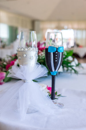 Beautiful decorated champagne glasses for newlyweds with flower.の写真素材