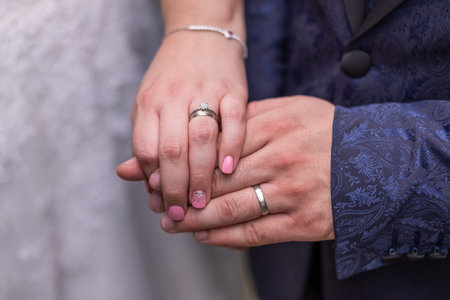 Close up of hands of a newly wed married couple with wedding rings.の写真素材