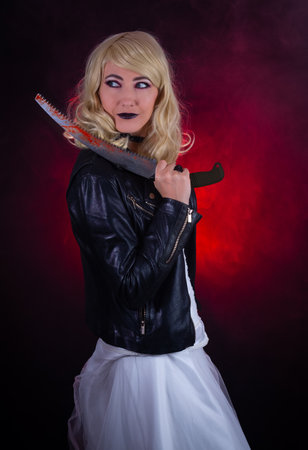 Scary woman in a wedding dress and a leather jacket.の写真素材
