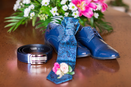 Small bouquet with flowers laying near man wedding clothes.の写真素材
