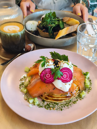 Coffee and a breakfast is on the table. Meal with a funny face.の写真素材