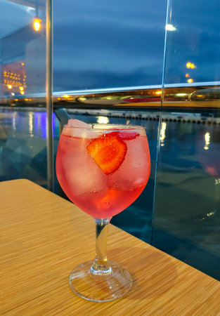 Close up of gin tonic drink is on the table. Red drink.の写真素材
