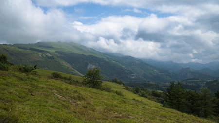Rolling green hills stretch across the landscape in northern Spain.の写真素材