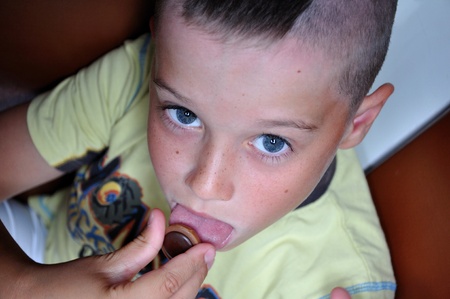 Cute boy with candyの写真素材