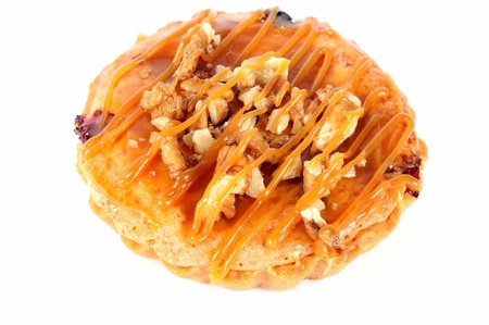 Delicious cake with nuts and cream on a white background 