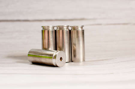 Bullets from the gun placed on a light wooden gray background.の写真素材