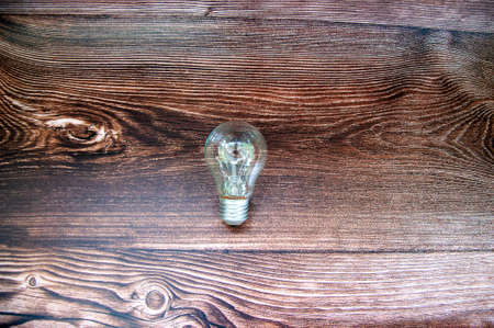 Light bulb over wooden background. Close up.の写真素材
