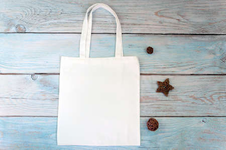 Tote bag canvas fabric cloth shopping sack mockup blank template on wooden background. Stock photo.の写真素材