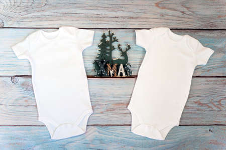 Layout Flat Put on a two christmas white baby bodysuit on a wooden background. Layout for design and placement of logos, advertising. Styled stock photography, stock photo. flat lay.の写真素材