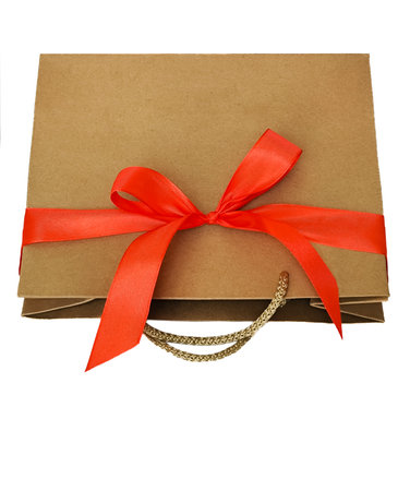 A craft bag with a red bow lies on a white background. Isolateの写真素材