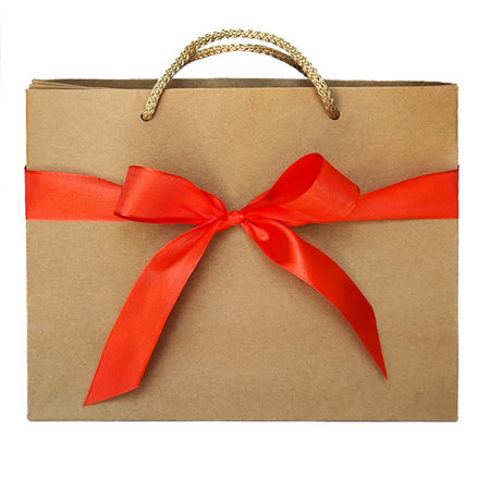 A craft bag with a red bow stands on a white background. Isolateの写真素材