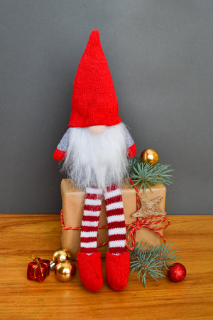 Christmas or New Year composition with a gnome, elf on a gray backgroundの写真素材