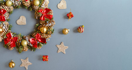 A Christmas wreath on a dark gray background. Top view with space for text.の写真素材