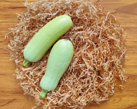 Fresh zucchini on a wooden background. Top view with space for text.の写真素材