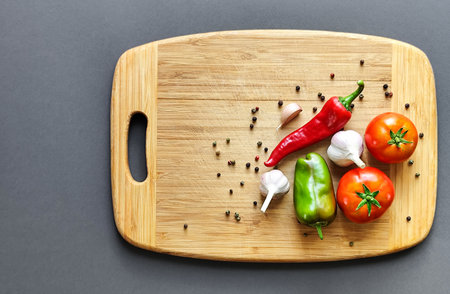 Composition of pepper, chili, garlic and tomato on a wooden surface.の写真素材