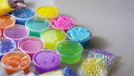 Defocused colorful slimes inside plastic boxes.の写真素材