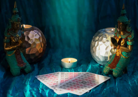Defocused mystic ritual with tarot cards, and candles.