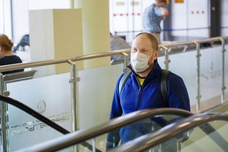 European redbeard man is in protective medical mask in airportのeditorial素材